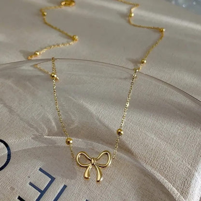 Golden Bow Pendant Necklace – Beaded Chain