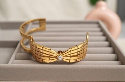 Gold Bow Bangle with Gemstone Center